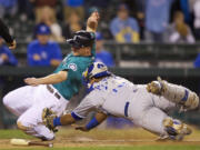 Kansas City Royals catcher Salvador Perez tags out Seattle Mariners base runner Kyle Seager at home plate when Seager tried to score on a sacrifice fly during the 10th inning Monday.