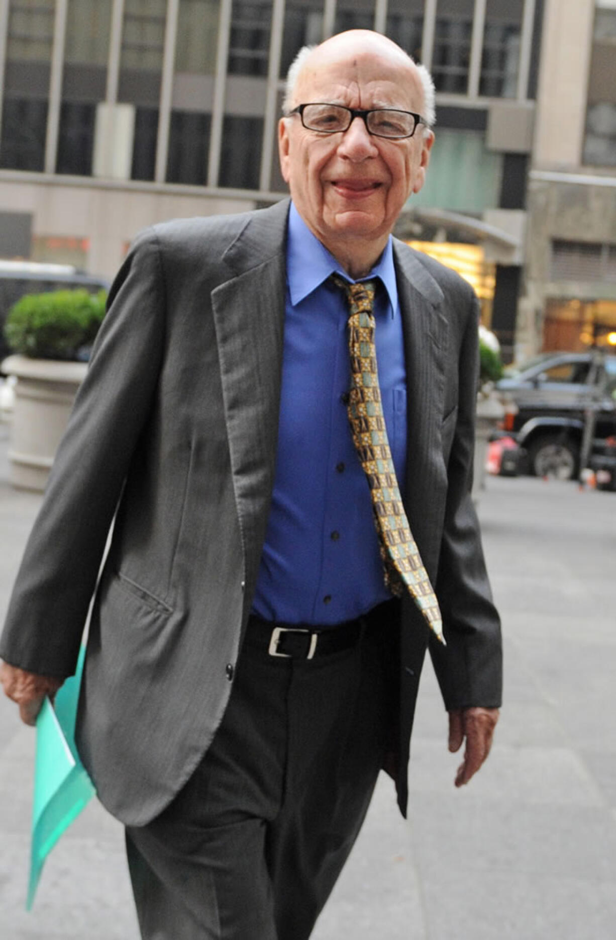 Chairman and Chief Executive Officer of News Corporation Rupert Murdoch enters the News Corp. building, in New York. Media mogul has resigned from a number of News Corp.