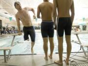 Ryker Phillips, 17, left, a senior on the Mountain View High School swim team exits the pool after competing in the 400 yard freestyle relay Jan.