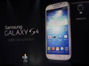 JK Shin, president and head of IT and Mobile Communications for Samsung Electronics, presents the new Samsung Galaxy S 4 during the Samsung Unpacked event at Radio City Music Hall on Thursday in New York.