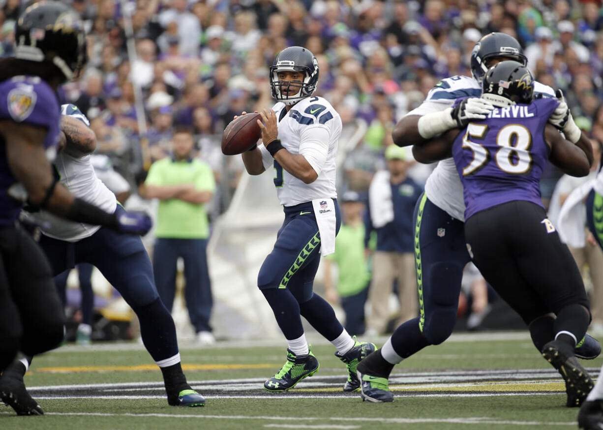 Seattle Seahawks quarterback Russell Wilson (3) looks to pass during the first half an NFL football game against the Baltimore Ravens, Sunday, Dec. 13, 2015, in Baltimore.