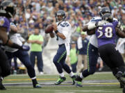 Seattle Seahawks quarterback Russell Wilson (3) looks to pass during the first half an NFL football game against the Baltimore Ravens, Sunday, Dec. 13, 2015, in Baltimore.