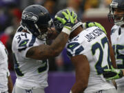 Seattle Seahawks running back Fred Jackson (22) celebrates his five-yard touchdown reception with Thomas Rawls (34) in the second half of an NFL football game against the Minnesota Vikings, Sunday, Dec. 6, 2015 in Minneapolis.