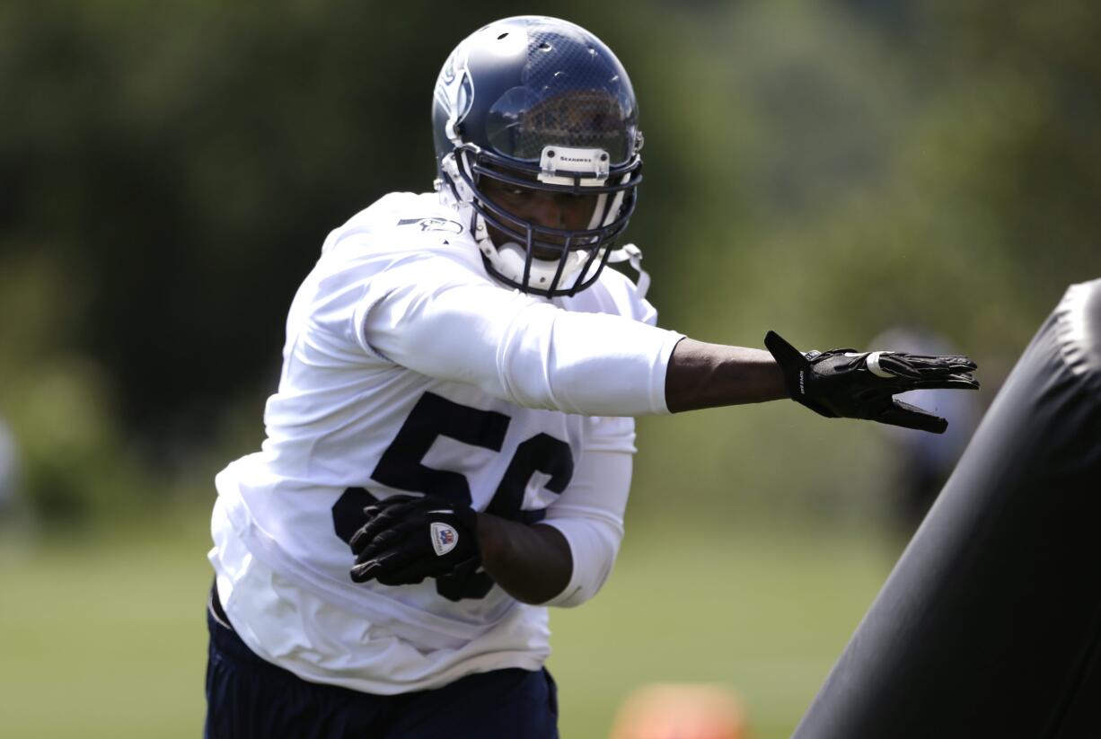 Seattle Seahawks' Cliff Avril runs through a drill during minicamp Tuesday at Renton.