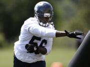 Seattle Seahawks' Cliff Avril runs through a drill during minicamp Tuesday at Renton.