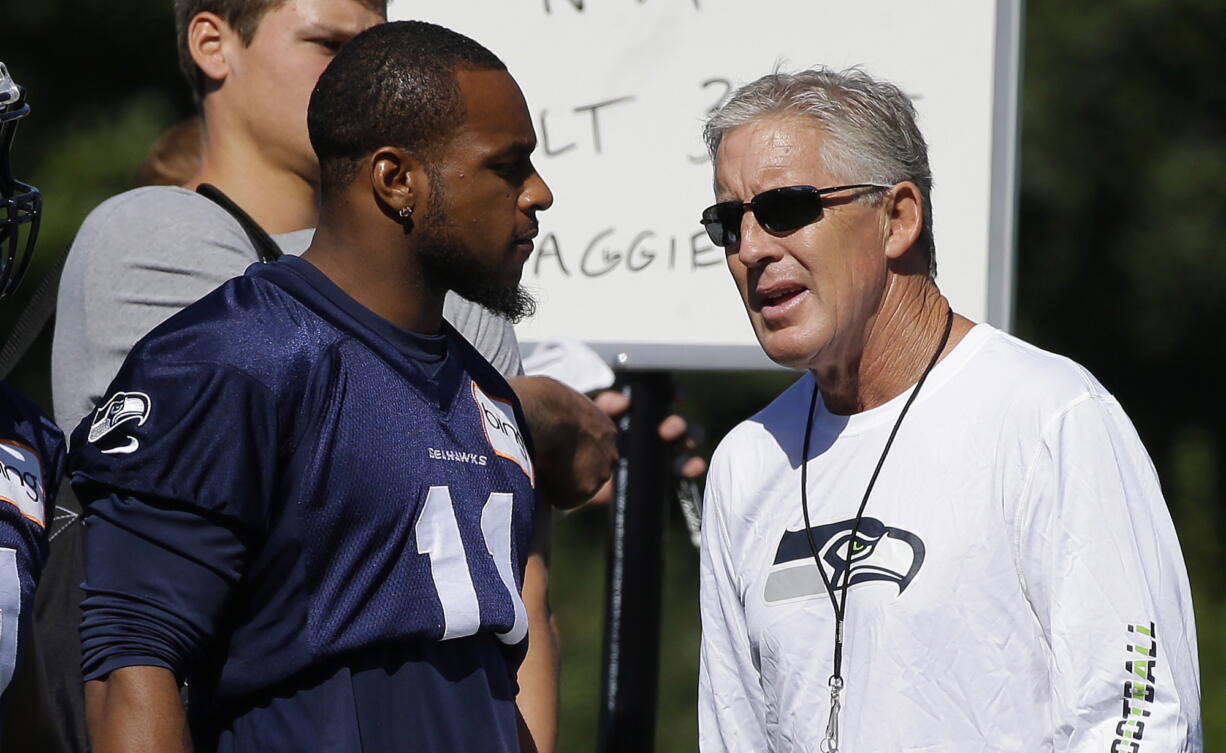 Seahawks wide receiver Percy Harvin, left with head coach Pete Carroll, has a hip injury that landed him on the physically unable to perform list.