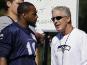 Seahawks wide receiver Percy Harvin, left with head coach Pete Carroll, has a hip injury that landed him on the physically unable to perform list.