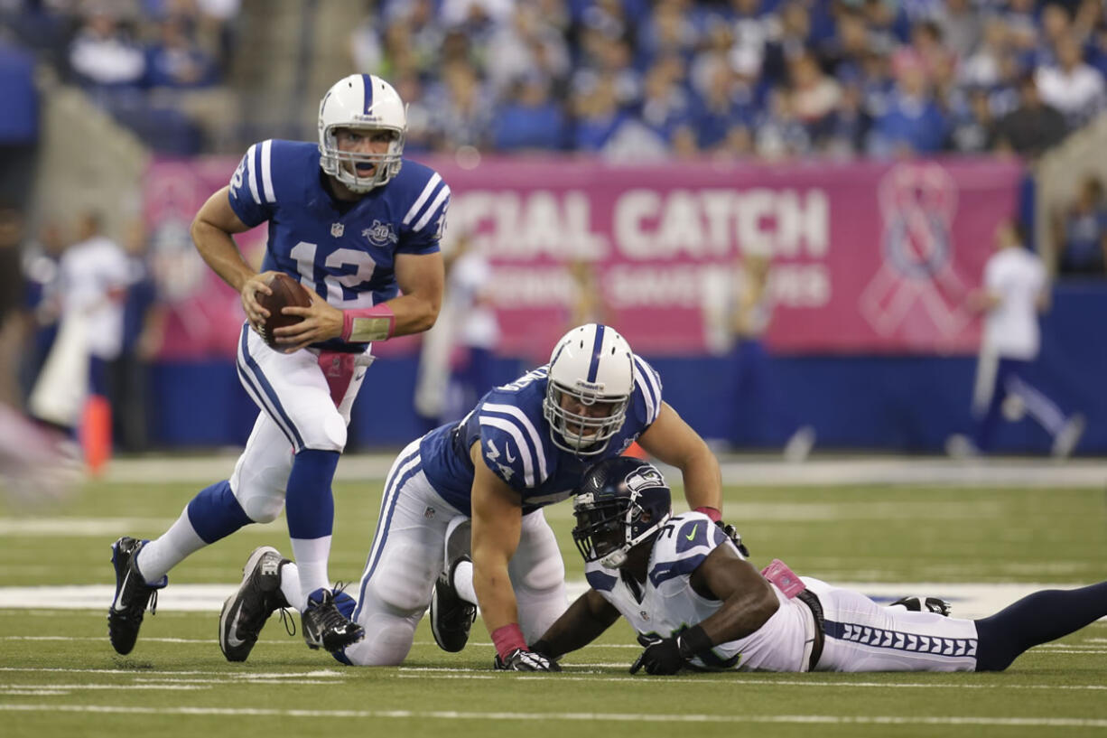 Indianapolis Colts quarterback Andrew Luck scramble against the Seattle Seahawks during the first half Sunday.