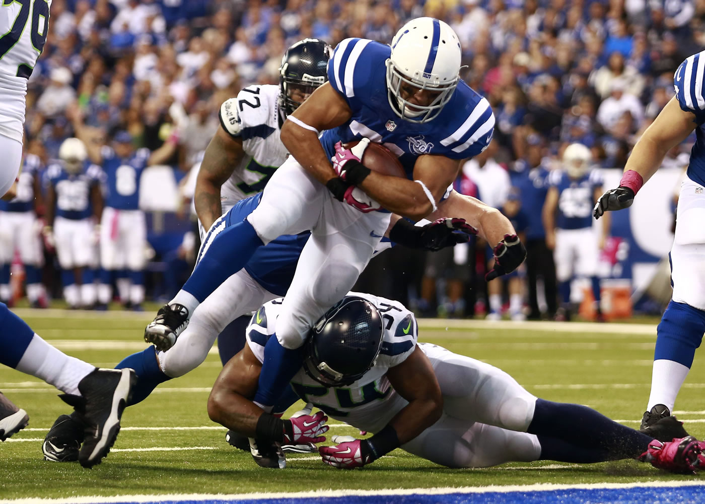 Indianapolis running back Donald Brown goes over Seattle linebacker Bobby Wagner to score the go-ahead touchdown in the fourth quarter Sunday.