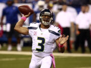 Seattle Seahawks quarterback Russell Wilson throws against the Indianapolis Colts during the first half of an NFL football game in Indianapolis, Sunday, Oct. 6, 2013. (AP Photo/Brent R.