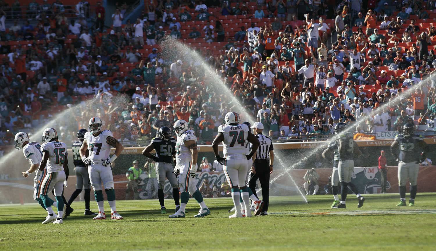 Action stopped in the third quarter Sunday at Sun Life Stadium when the field sprinkers turned on.