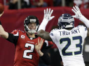 Atlanta Falcons quarterback Matt Ryan (2) throws as Seattle Seahawks cornerback Marcus Trufant (23) tries to make the stop during the second half Sunday.