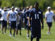 Injured Seattle Seahawks wide receiver Percy Harvin (11) walks off the field following NFL football training camp on Saturday, July 27, 2013, in Renton, Wash. Harvin will get a second opinion on his sore hip next week in New York, and Seattle coach Pete Carroll says all options remain for how the injury is handled. (AP Photo/Ted S.