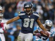 Seattle Seahawks' Golden Tate (81) reacts after his touchdown catch against the Carolina Panthers during the third quarter of an NFL football game in Charlotte, N.C., Sunday, Oct. 7, 2012.