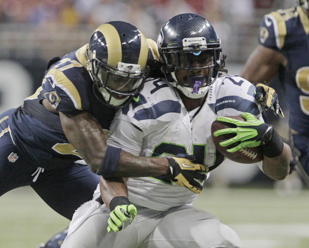 Seattle Seahawks running back Marshawn Lynch is tackled by St. Louis Rams free safety Quintin Mikell during the second half Sunday.