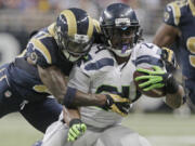 Seattle Seahawks running back Marshawn Lynch is tackled by St. Louis Rams free safety Quintin Mikell during the second half Sunday.