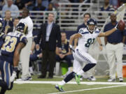 Seattle Seahawks wide receiver Golden Tate (81) runs to the end zone for a touchdown during the second half of an NFL football game against the St. Louis Rams, Monday, Oct. 28, 2013, in St. Louis.