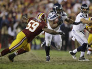 Seattle Seahawks running back Marshawn Lynch runs past Washington Redskins inside linebacker London Fletcher as he heads toward the end zone for a touchdown Sunday.