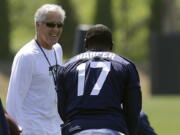 Seattle Seahawks head coach Pete Carroll, left, talks to Chris Harper during minicamp drills Friday at Renton.