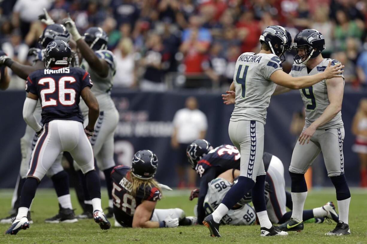 Seattle Seahawks' Jon Ryan (9) celebrates with kicker Steven Hauschka (4) after Hauschka kicked the winning field goal against the Houston Texans in overtime Sunday.