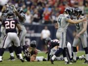 Seattle Seahawks' Jon Ryan (9) celebrates with kicker Steven Hauschka (4) after Hauschka kicked the winning field goal against the Houston Texans in overtime Sunday.