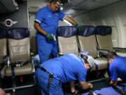 Southwest Airlines aircraft technicians install newer, skinnier seats on a 737 at the carrier's headquarters in Dallas.