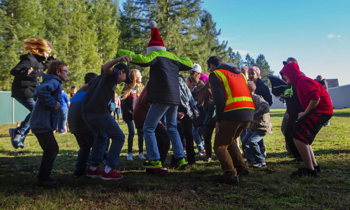 Sixth-grade students jump to help researchers measure the way seismic waves move through soil at Lackamas Elementary School in Yelm, near Olympia. (Photos by Ellen M.