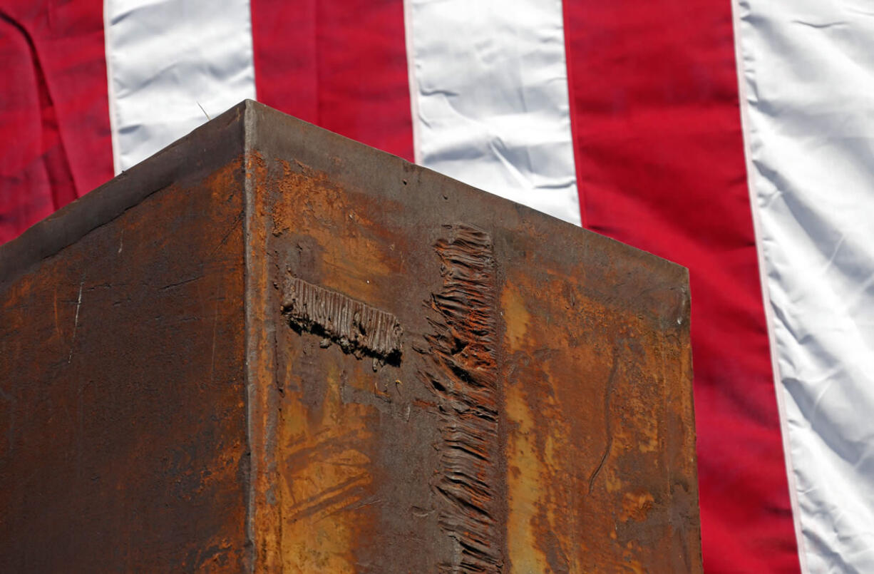 A 22-foot-tall column from the South Tower of the World Trade Center is seen with a large flag behind during the Los Angeles Fire Department's Sept.