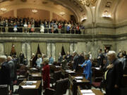 Senators and visitors in the gallery recite the Pledge of Allegiance on the Senate floor  Monday at the Capitol in Olympia on the first day of the 2013 legislative session. In the foreground at right is Sen.