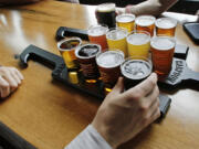 A couple taste a selection of 12 different beer flights at the Beer Hall at the Harpoon Brewery in Boston.