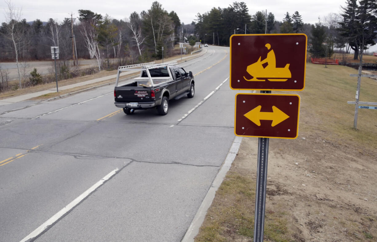 A snowmobile crossing sign is seen Tuesday along Route 30 in Speculator, N.Y. Some Northeasterners are beginning to wonder if a white Christmas may just be a dream.