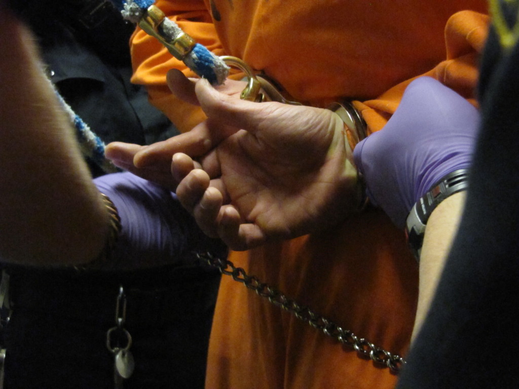 Guards work to change the restraints on an inmate March 14, 2015, at the at the Washington State Penitentiary in Walla Walla.