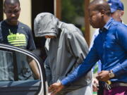 Olympic athlete Oscar Pistorius leaves the Boschkop police station, east of Pretoria, South Africa, in 2013 while in custody after the shooting death of his girlfriend Reeva Steenkamp, at his home.