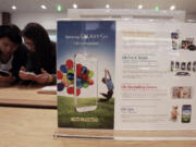 Visitors operate Samsung Electronics' Galaxy S4 smartphones Friday at a showroom in its headquarters in Seoul, South Korea. Samsung Electronics Co.