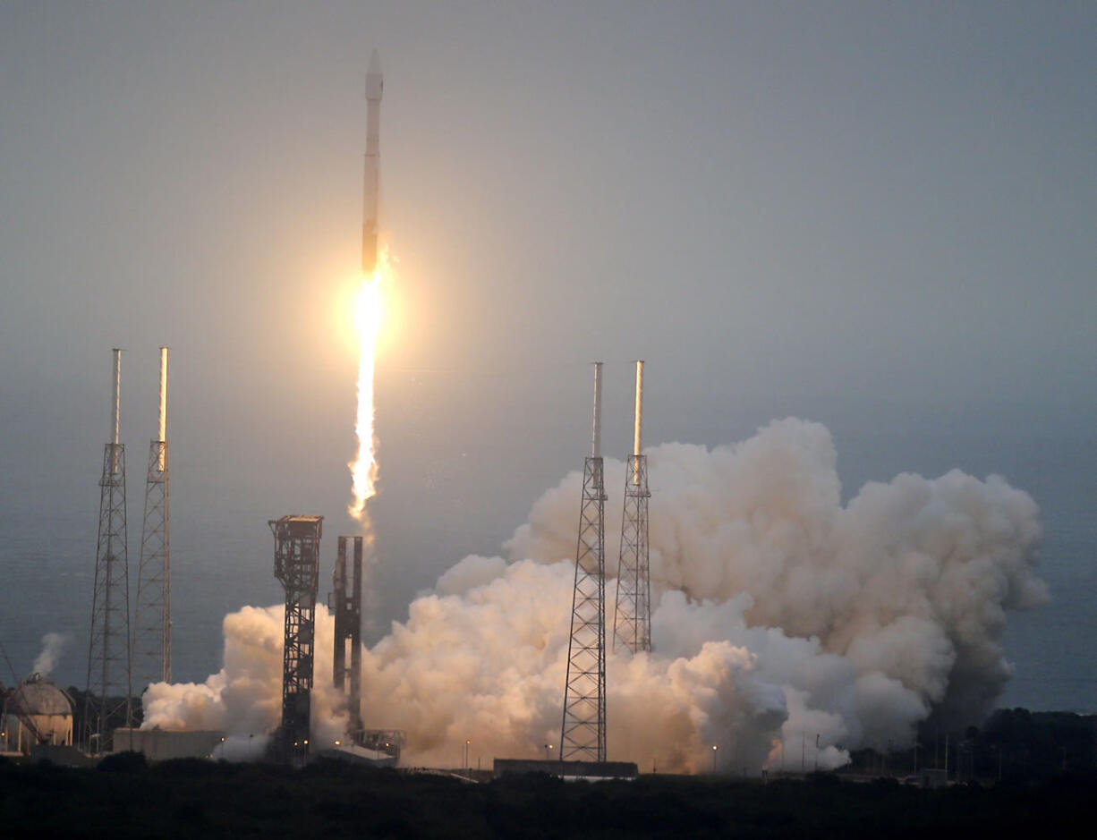 A United Launch Alliance Atlas V rocket lifts off Sunday from Cape Canaveral, Fla. The rocket is delivering supplies to the International Space Station.