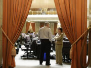 House Speaker Frank Chopp, left, D-Seattle, talks with Rep.