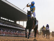 Victor Espinoza reacts after crossing the finish line with American Pharoah to win the Belmont Stakes on June 6, 2015, at Belmont Park in Elmont, N.Y. American Pharoahs sweep of the Kentucky Derby, Preakness and Belmont Stakes for horse racings first Triple Crown since 1978 was selected the sports story of the year Thursday, Dec. 24, 2015, in an annual vote conducted by The Associated Press.