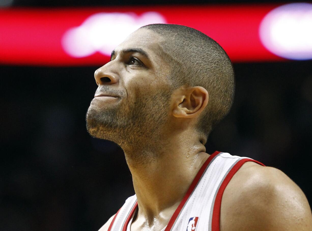 Portland Trail Blazers forward Nicolas Batum, from France, grimaces after missing a three point shot with just seconds to go during the second half of their NBA basketball game against the San Antonio Spurs in Portland, Ore., Saturday, Nov. 10, 2012.