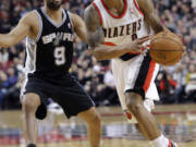 Portland's Damian Lillard drives past San Antonio's Tony Parker during Thursday's game.