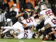 Stanford's Tyler Gaffney (25) works against Oregon State defenders during the first half of an NCAA college football game in Corvallis, Ore., Saturday Oct. 26, 2013.