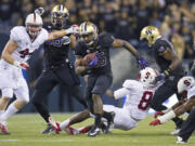 Washington's Bishop Sankey gets past Stanford defenders on a 61-yard touchdown during the third quarter Thursday.