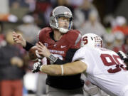 Stanford's Josh Mauro, right, forces a fumble by Washington State quarterback Connor Halliday on a sack in the first half Saturday.