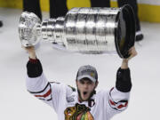 Stanley Cup Final MVP Patrick Kane hoists the Stanley Cup after beating the Boston Bruins 3-2 in Game 6 of the Stanley Cup Final on Monday.