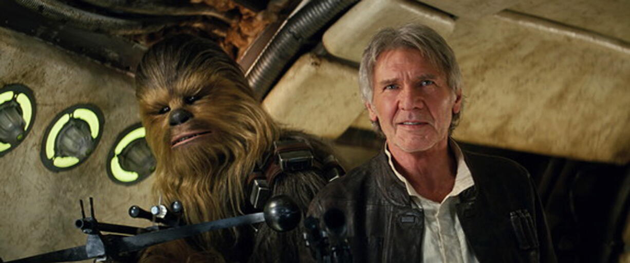 Peter Mayhew as Chewbacca and Harrison Ford as Han Solo appear in a scene from &quot;Star Wars: The Force Awakens.&quot; The movie opened in U.S. theaters Friday and earned $238 million over the weekend, making it the biggest North American debut of all time, according to studio estimates on Sunday.