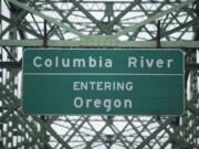 A road sign on the Interstate 5 Bridge heading southbound welcomes drivers to Oregon.