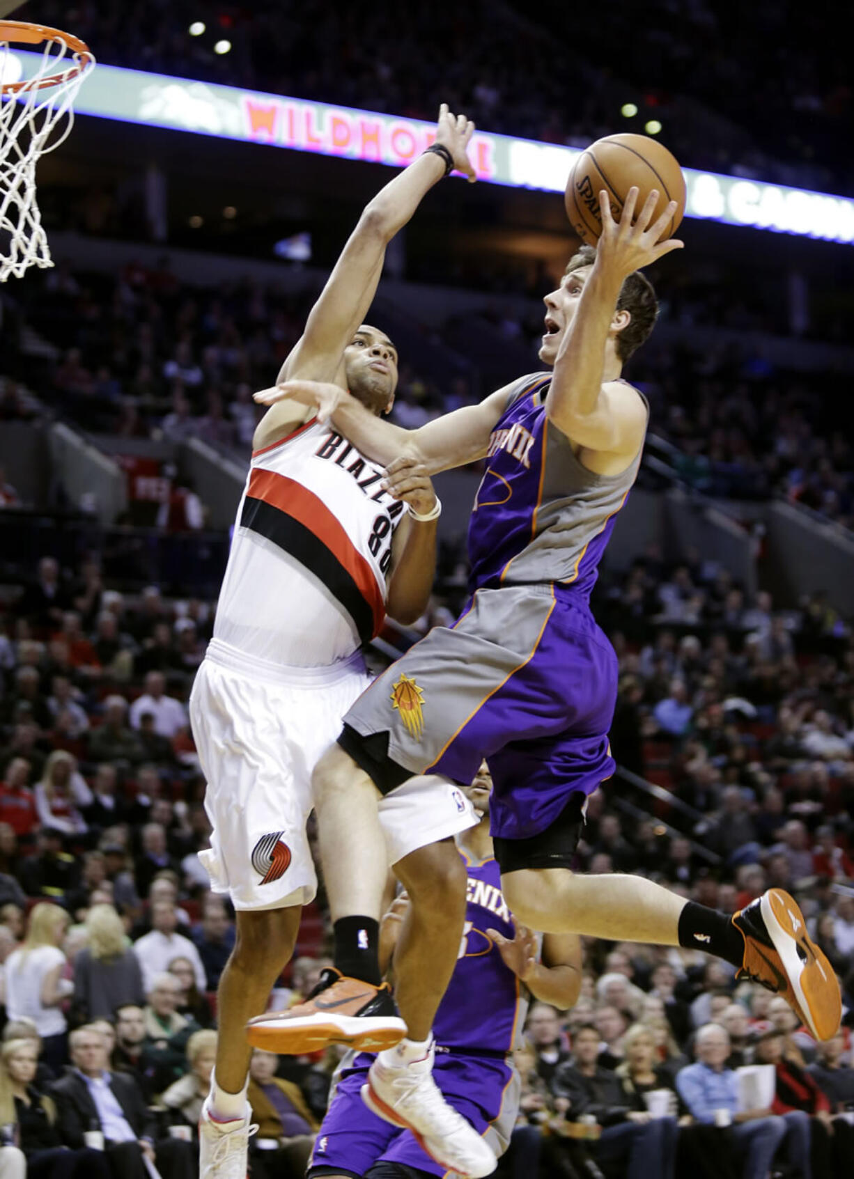 DON RYAN/The Associated Press
Portland forward Nicolas Batum tries to stop Phoenix guard Goran Dragic as the Blazers' rally from a 16-point fourth-quarter deficit comes up just short.