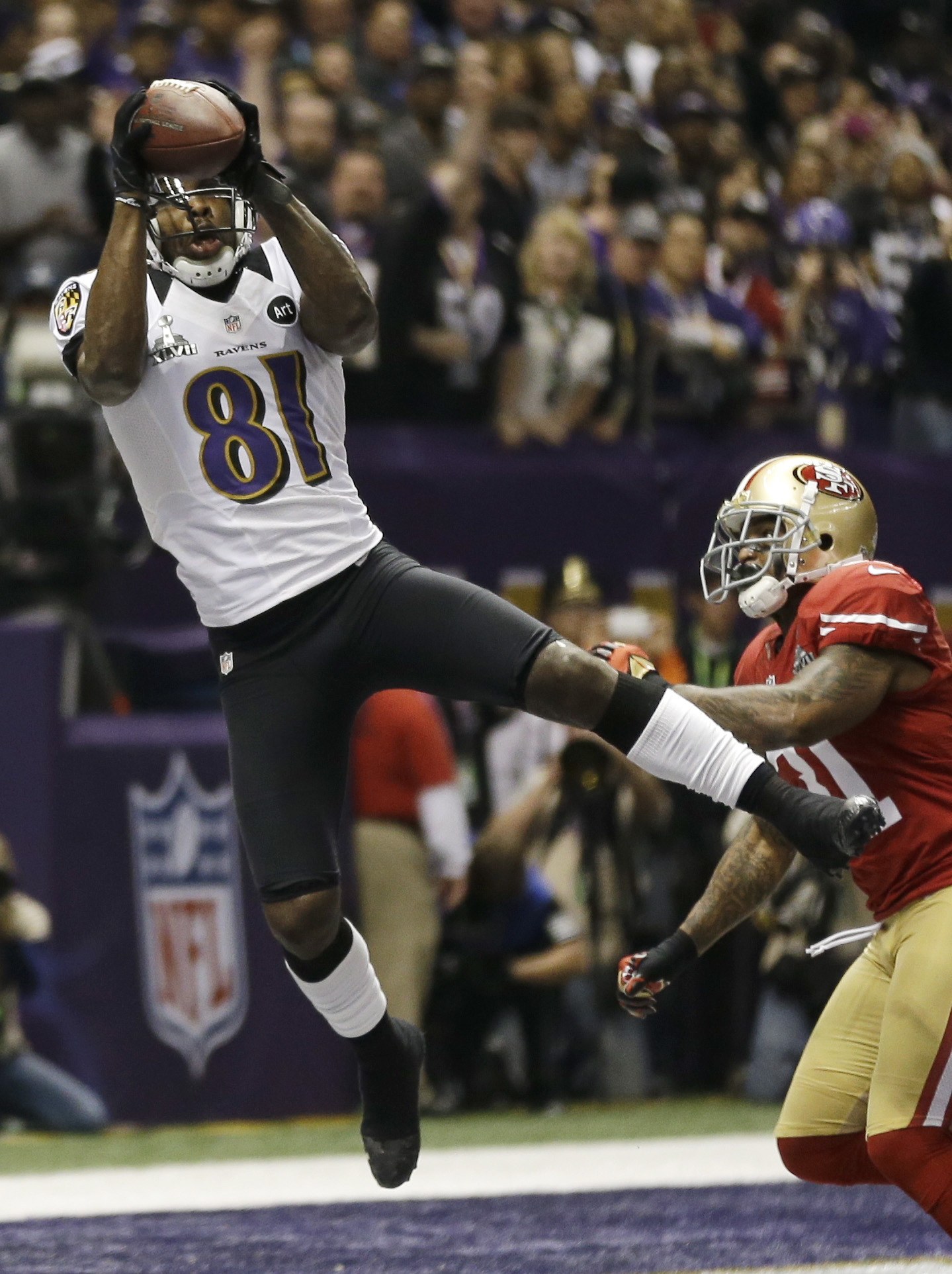 Baltimore Ravens wide receiver Anquan Boldin (81) catches a 13-yard touchdown pass against San Francisco 49ers safety Donte Whitner during the first half Sunday.Boldin caught six passes for 104 yards and scored the game's first touchdown.