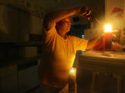 Minet Watson lights a candle in her home in Miami Shores, Fla., after Hurricane Katrina knocked out power in 2005.