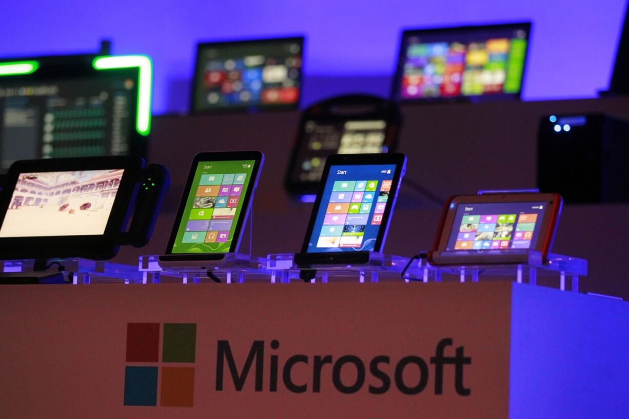 Computing devices running the Microsoft operating systems are displayed at the start of Microsoft Corporation's unveiling event.