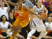 Oregon State's Jamie Weisner, right, protects the ball from Tennessee's Jordan Reynolds during the second half of an NCAA college basketball game in Corvallis, Ore., on Saturday, Dec. 19, 2015. Tennessee won 53-50. (AP Photo/Timothy J.